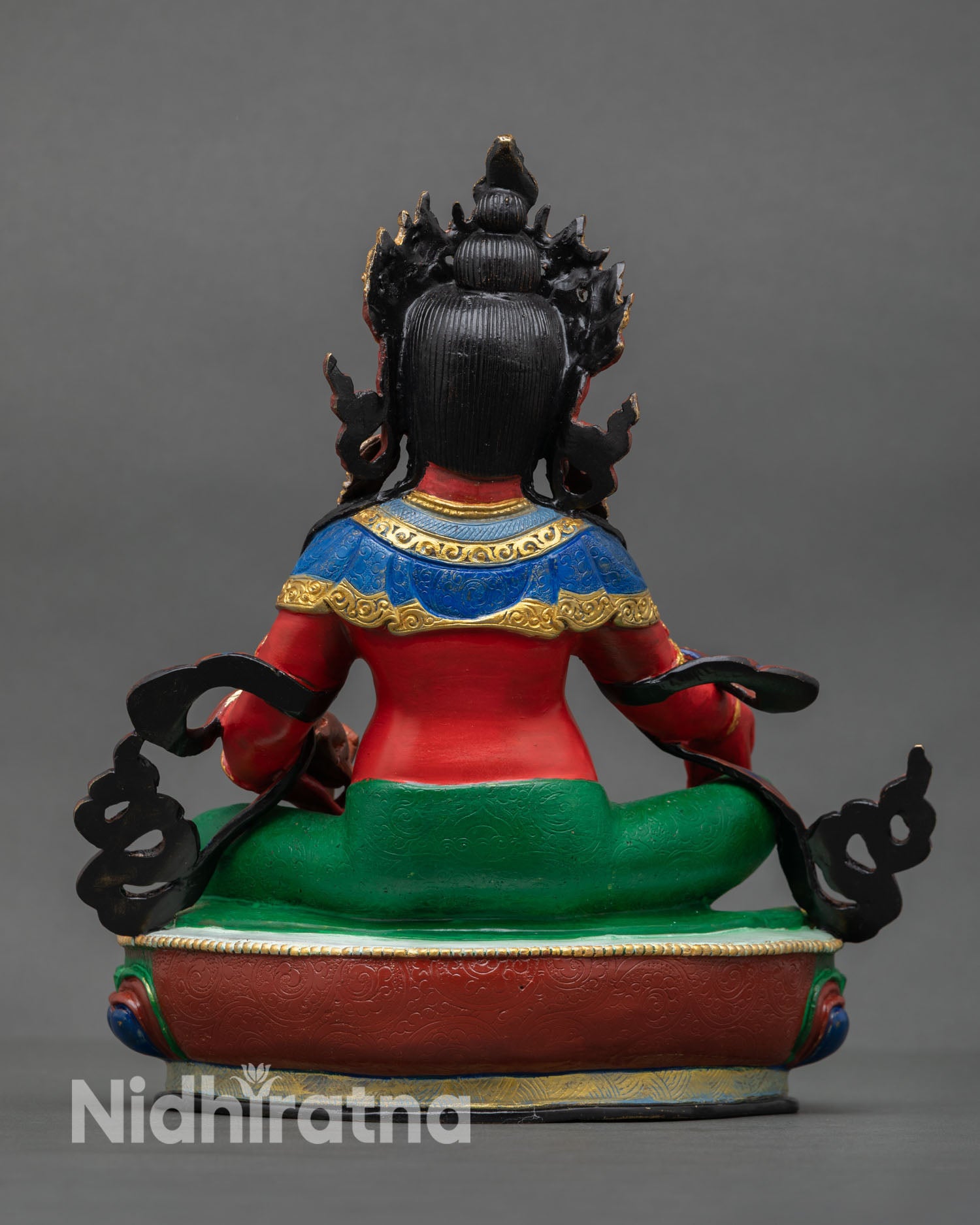 Back view of Dzambhala statue Nepal sacred artwork ornate lotus base handcrafted Buddhist wealth deity sculpture for spiritual decor