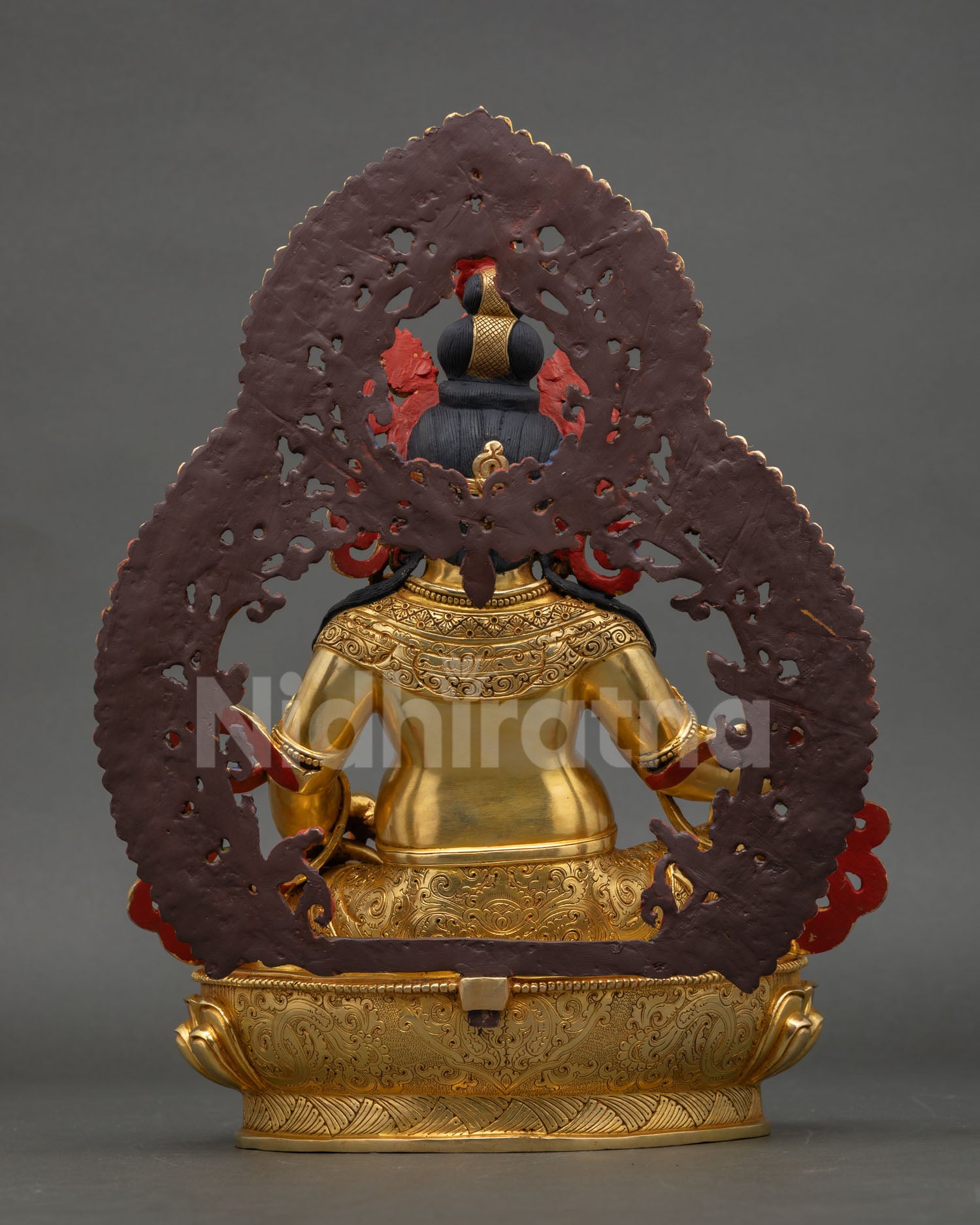 Back view of Dzambhala wealth deity statue with ornate halo structure hand painted acrylic detailing and traditional Himalayan metal craftsmanship