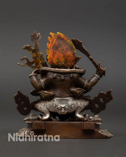 Back view of Four-Armed Mahakala handcrafted statue intricate detailing copper oxidized finish Tibetan Buddhist altar protector decor
