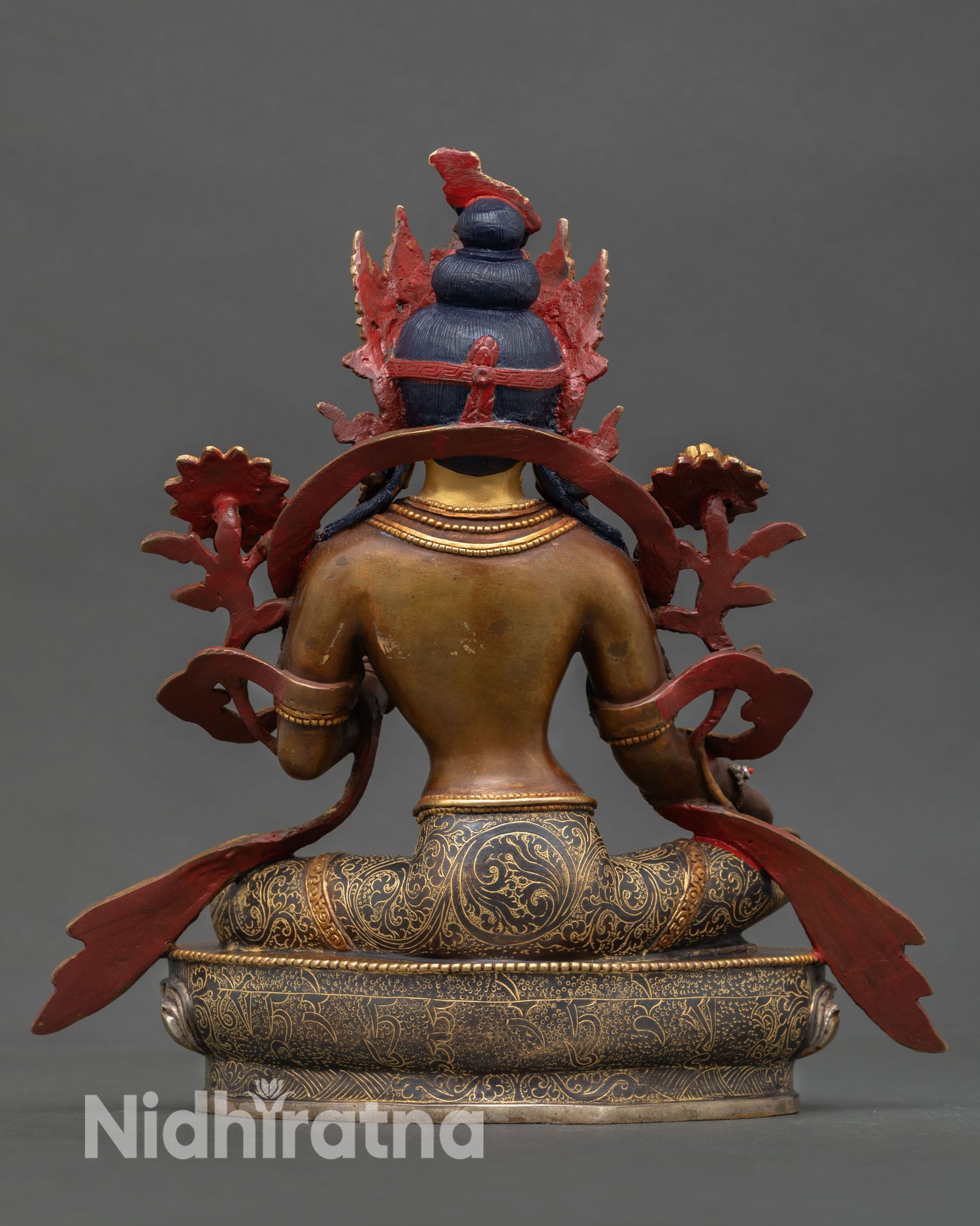 Back view of Green Tara statue Newari craftsmanship Patan Nepal oxidized copper body gold accents lotus base spiritual altar decor detail