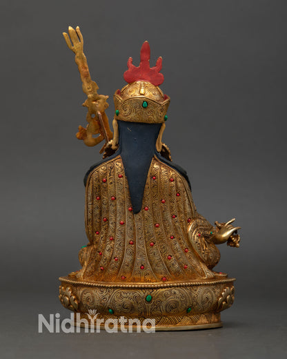 Back view of Guru Rinpoche statue handcrafted Nepal, intricate carving layered robes lotus pedestal, sacred Vajrayana Buddhist deity art