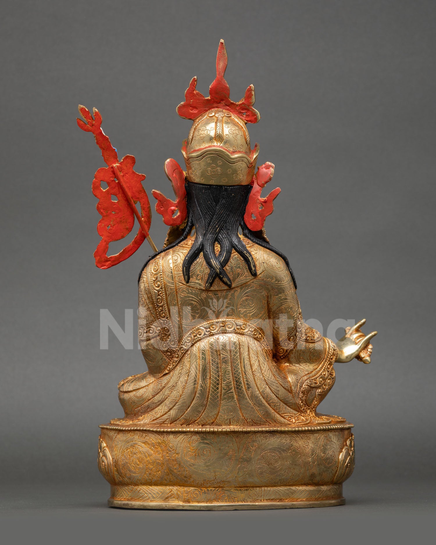 Back view of Guru Rinpoche statue Himalayan Buddhist deity sculpture seated lotus pedestal detailed carving gold copper finish