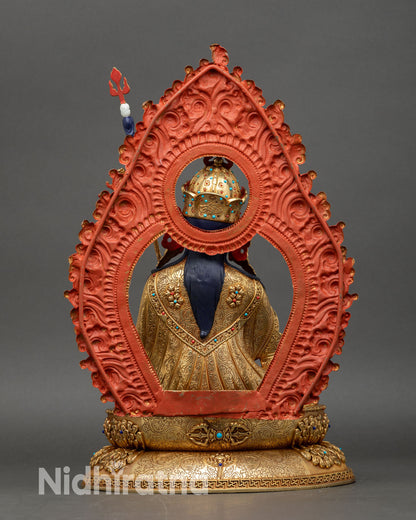 Back view of Guru Rinpoche statue with ornate lotus throne and elaborately carved halo