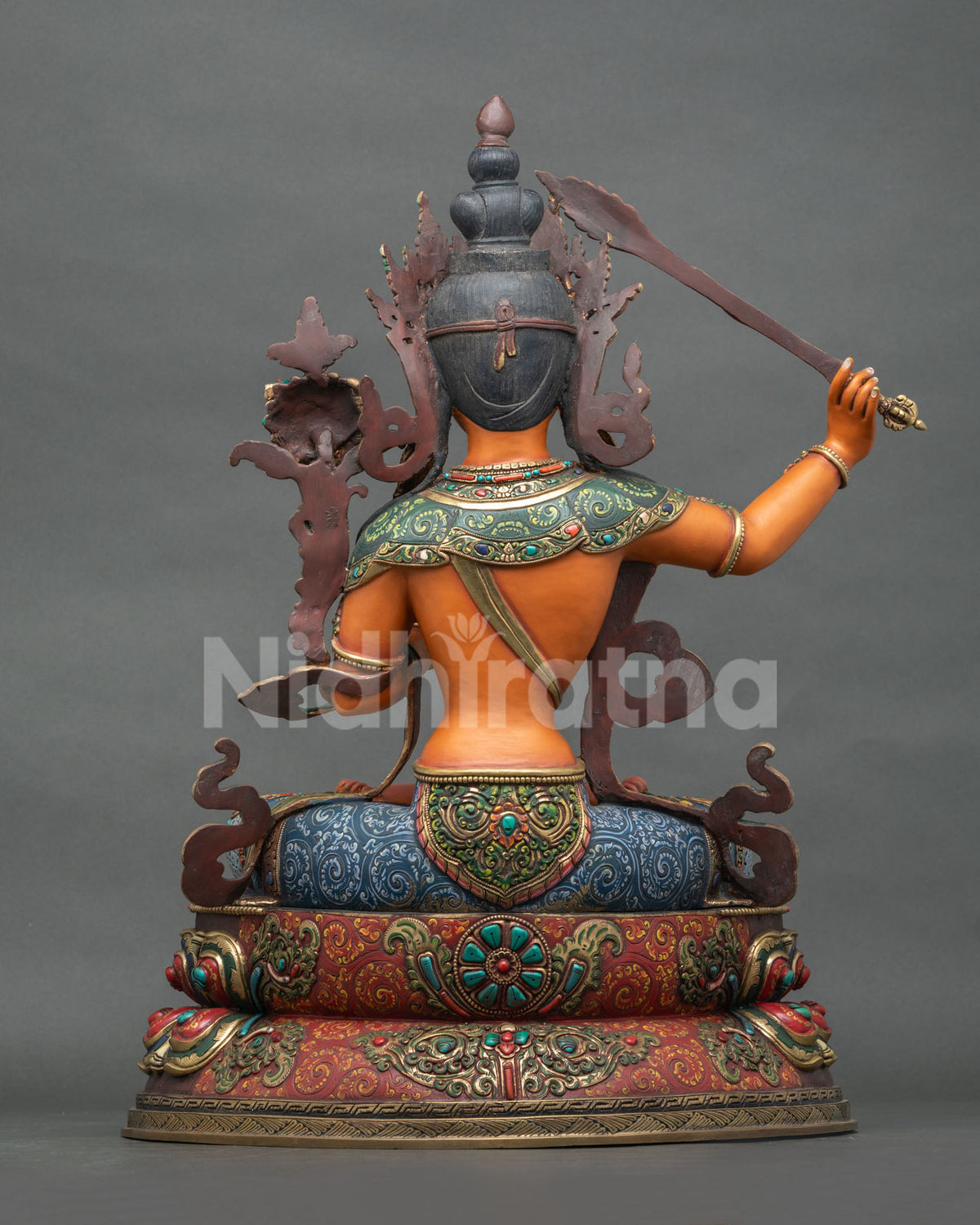 Back view of hand-carved copper Manjushri Statue showing detailed craftsmanship