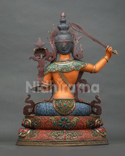 Back view of hand-carved copper Manjushri Statue showing detailed craftsmanship
