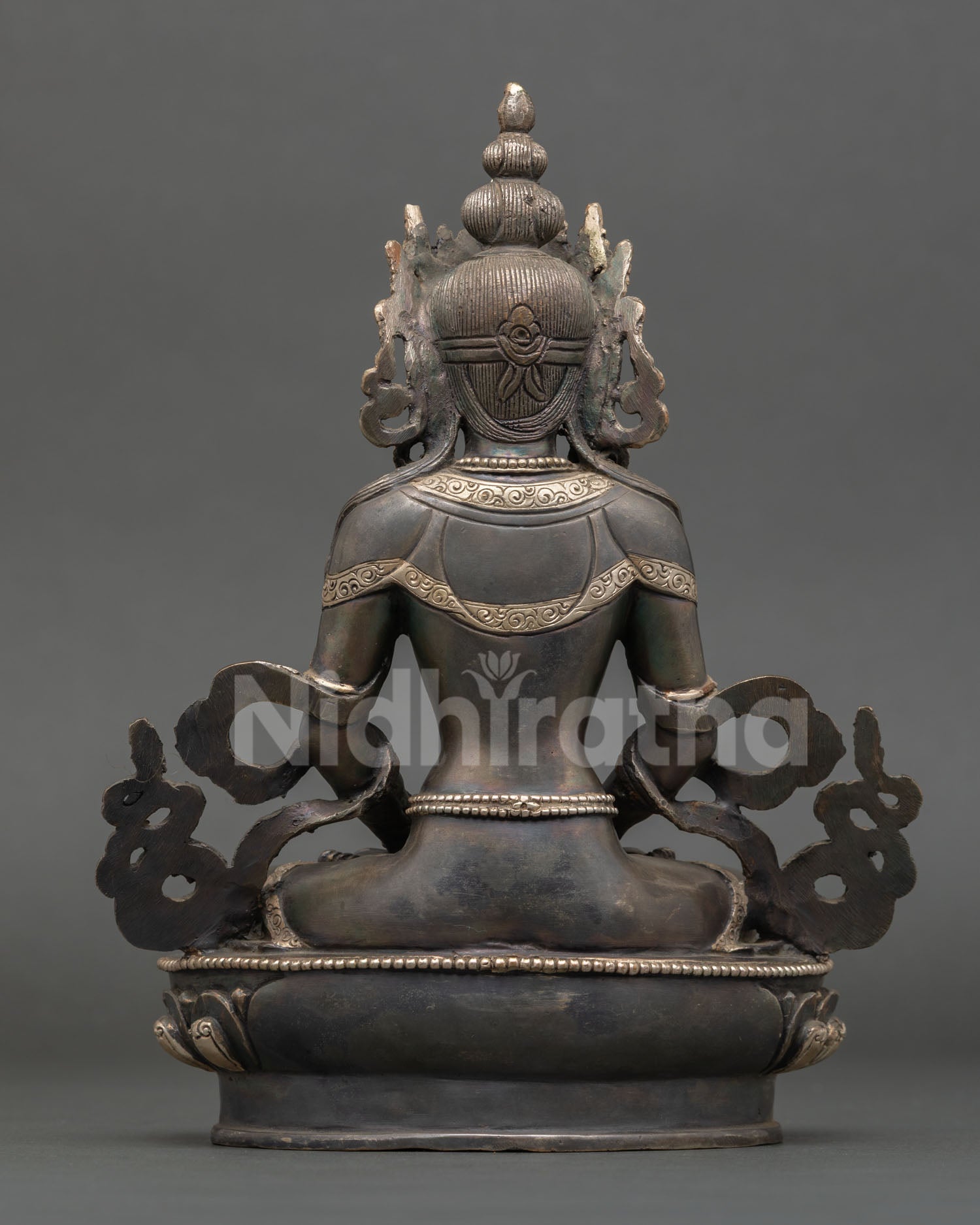 Back view of handcrafted Amitayus statue from Nepal with design ornate lotus base and traditional Himalayan metal artistry craftsmanship.
