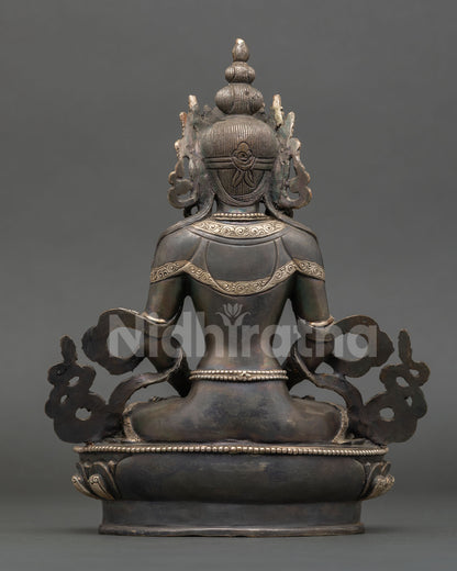 Back view of handcrafted Amitayus statue from Nepal with design ornate lotus base and traditional Himalayan metal artistry craftsmanship.