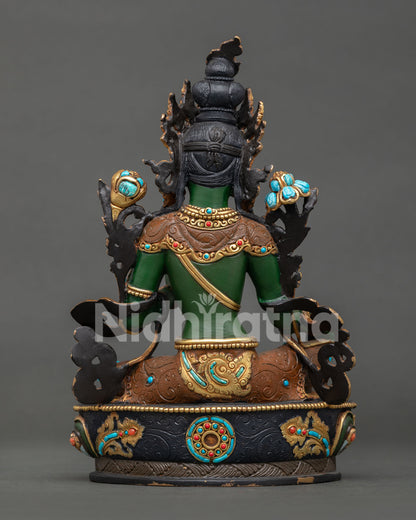 Back view of a handcrafted Green Tara statue with detailed robes and gold-gilded accents
