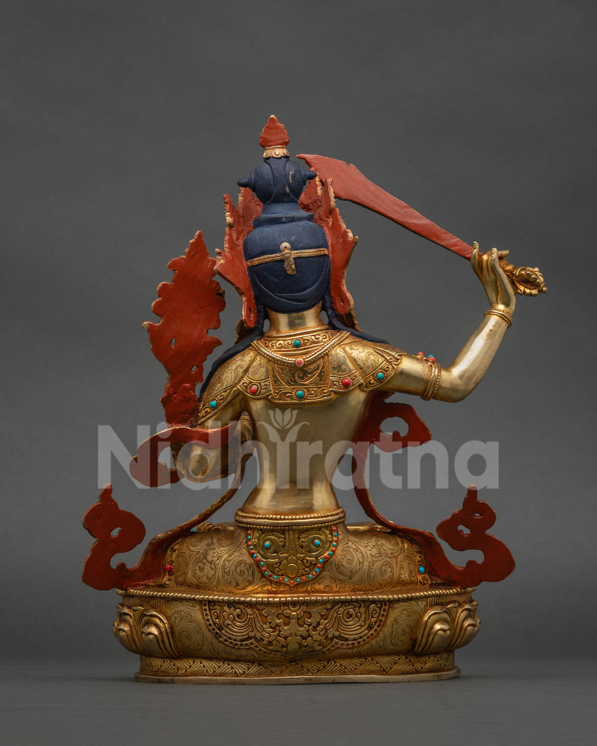 Back view of handcrafted Manjushri copper statue showing detailed gold gilded ornaments