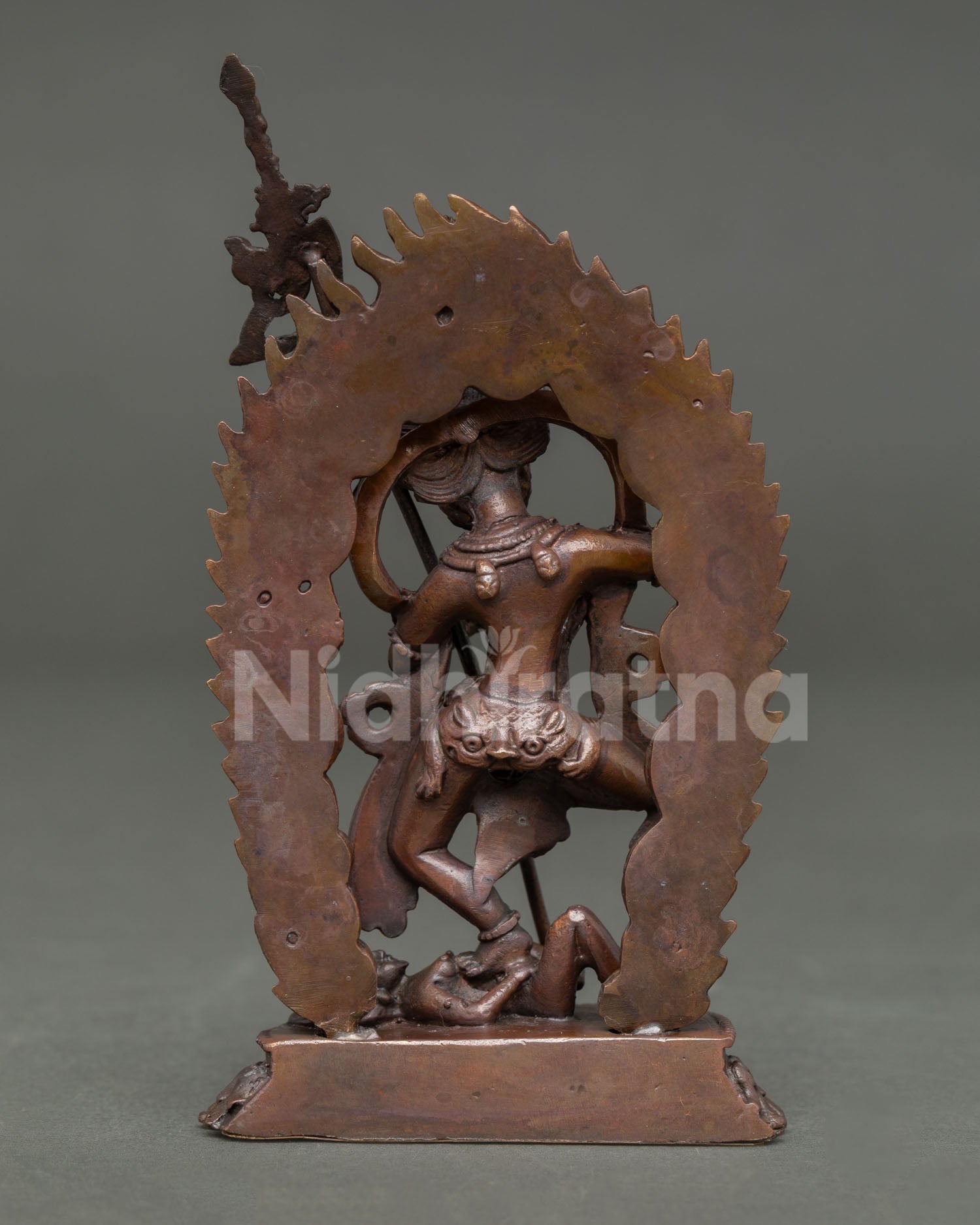 Back view of handcrafted Simhamukha statue from Patan Nepal showcasing oxidized copper and traditional Himalayan artistry