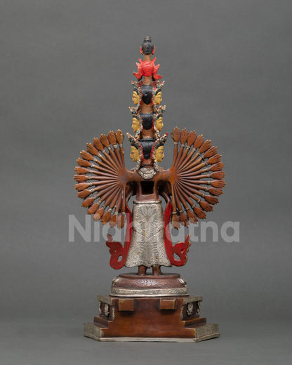 Back view of handmade Chenrezig statue, standing on lotus pedestal with oxidized copper finish