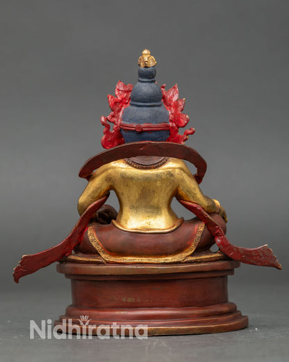 Back view of handmade Dzambhala statue from Kathmandu Nepal copper sculpture gold gilded antique finish intricate carved garments sacred altar decor