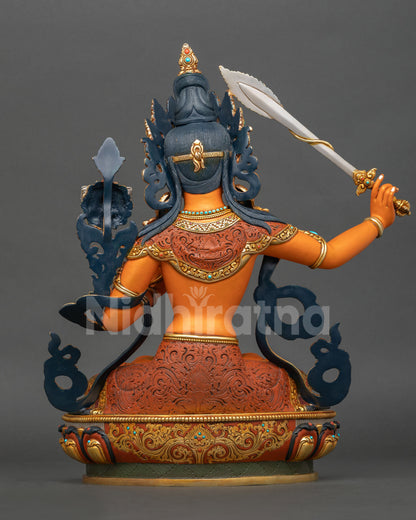 Back view of handmade Manjushri statue showing detailed metal craftsmanship gold gilded accents and traditional Newari artistry