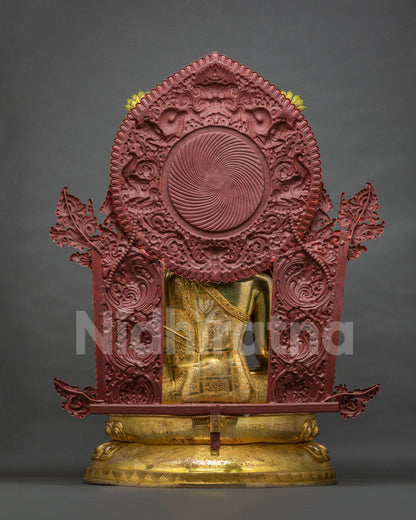Back view of Jowo Rinpoche statue showing gold robe and red painted halo