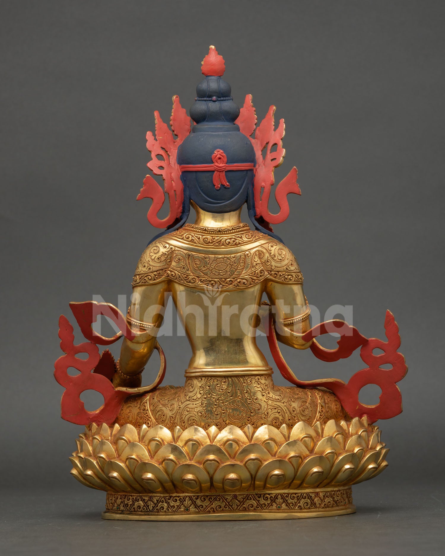 Back view of Kshitigarbha Buddhist statue, blooming lotus throne reflecting Himalayan spiritual artistry.