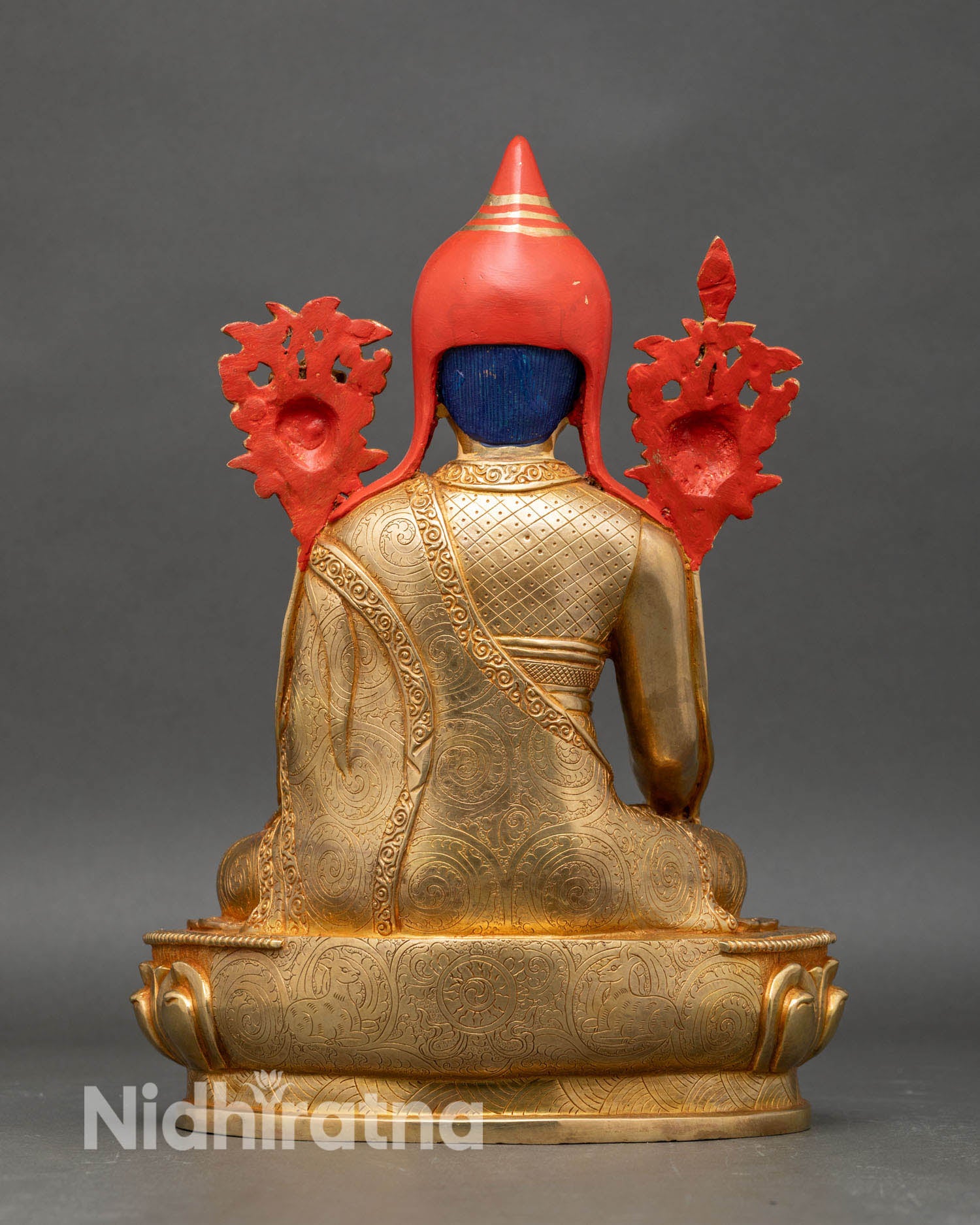 Back view of Longchenpa statue showing intricate robes, sacred motifs, and polished lotus pedestal.