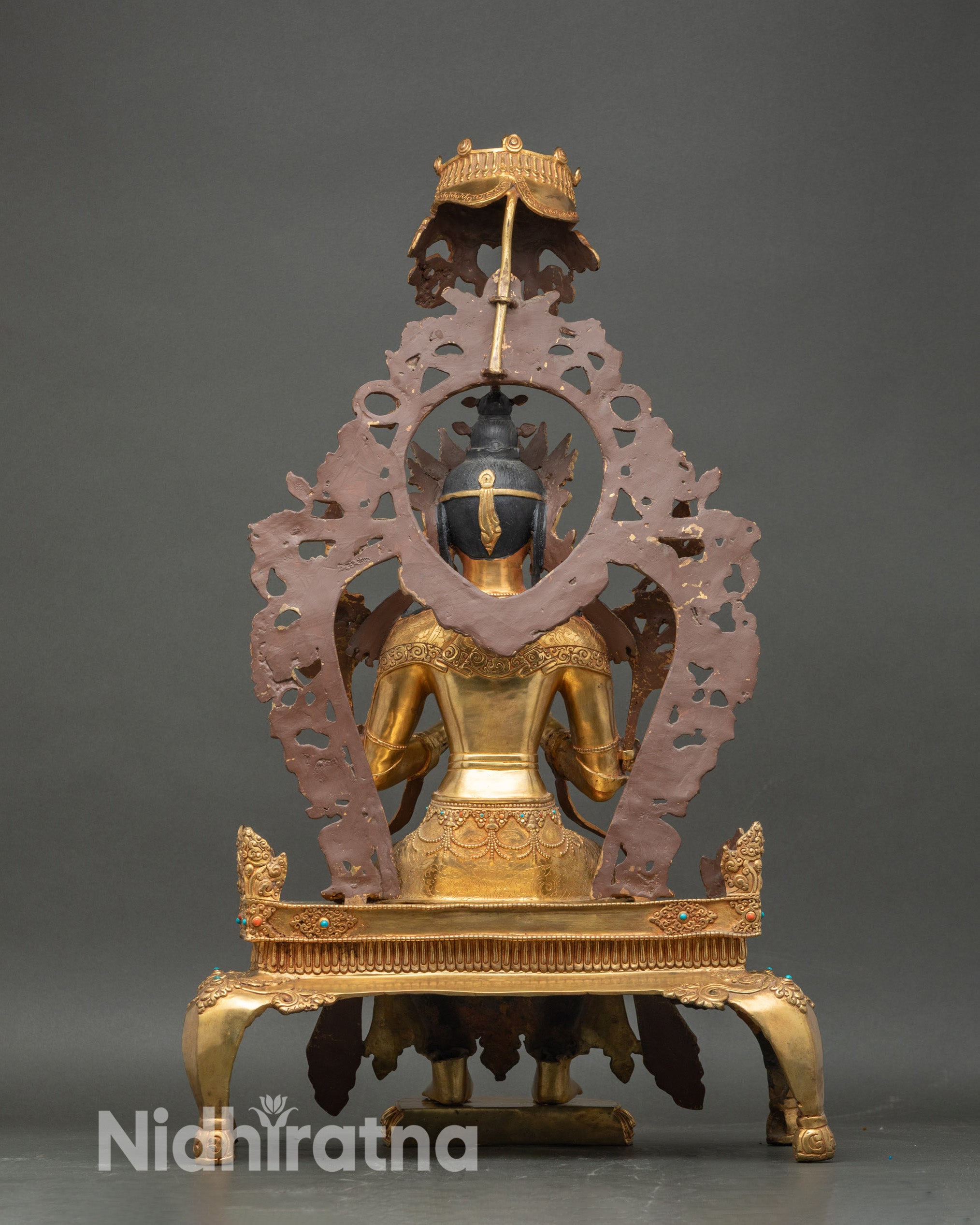 back view of maitreya buddha statue, intricate throne carving and halo frame