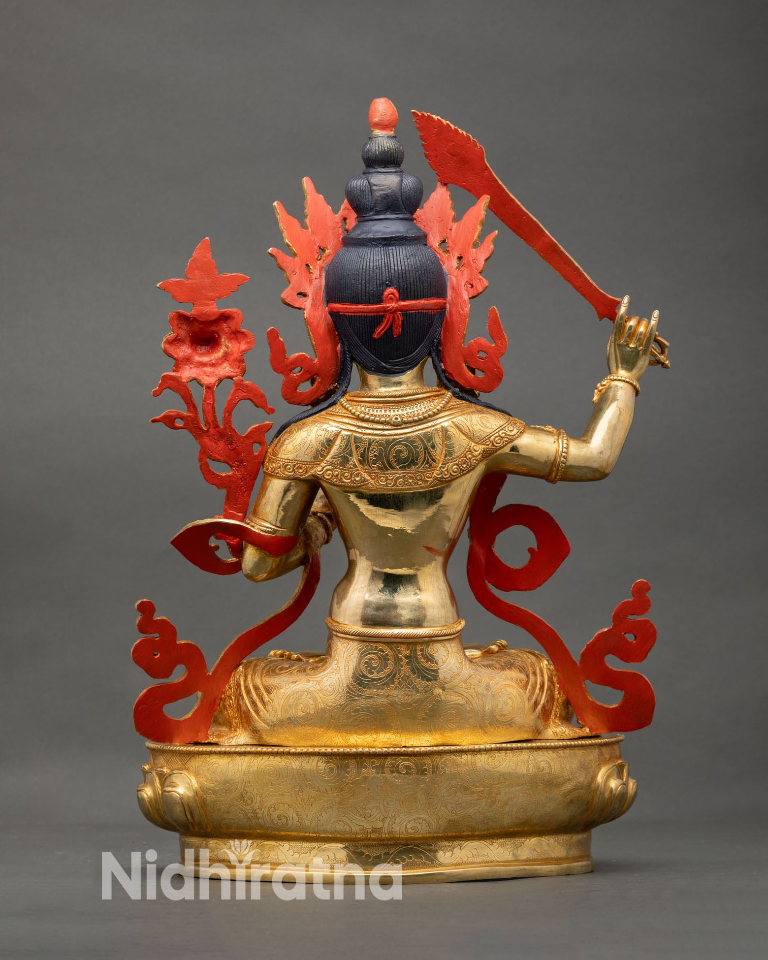 Back view of Manjushree statue showing detailed robes lotus base and sacred floral Utpala motifs Nepal