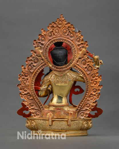 Back view of Manjushri handcrafted statue repoussé scrollwork floral halo copper Tibetan Buddhist meditation altar spiritual decor