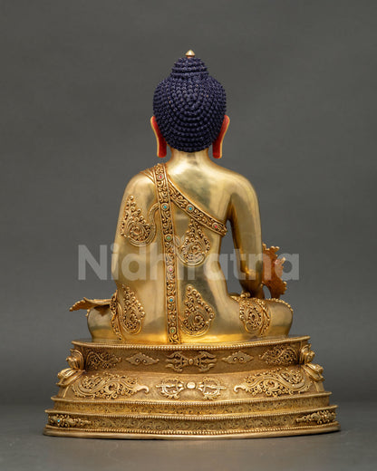 Medicine Buddha back view, hand-finished copper, engraved lotus base, gold fire-gilded — Nepal