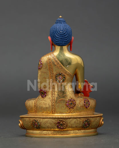 Back view of Medicine Buddha Buddhist statue with ornate craftsmanship flowing robe detailing and authentic lost wax Nepalese metal artistry