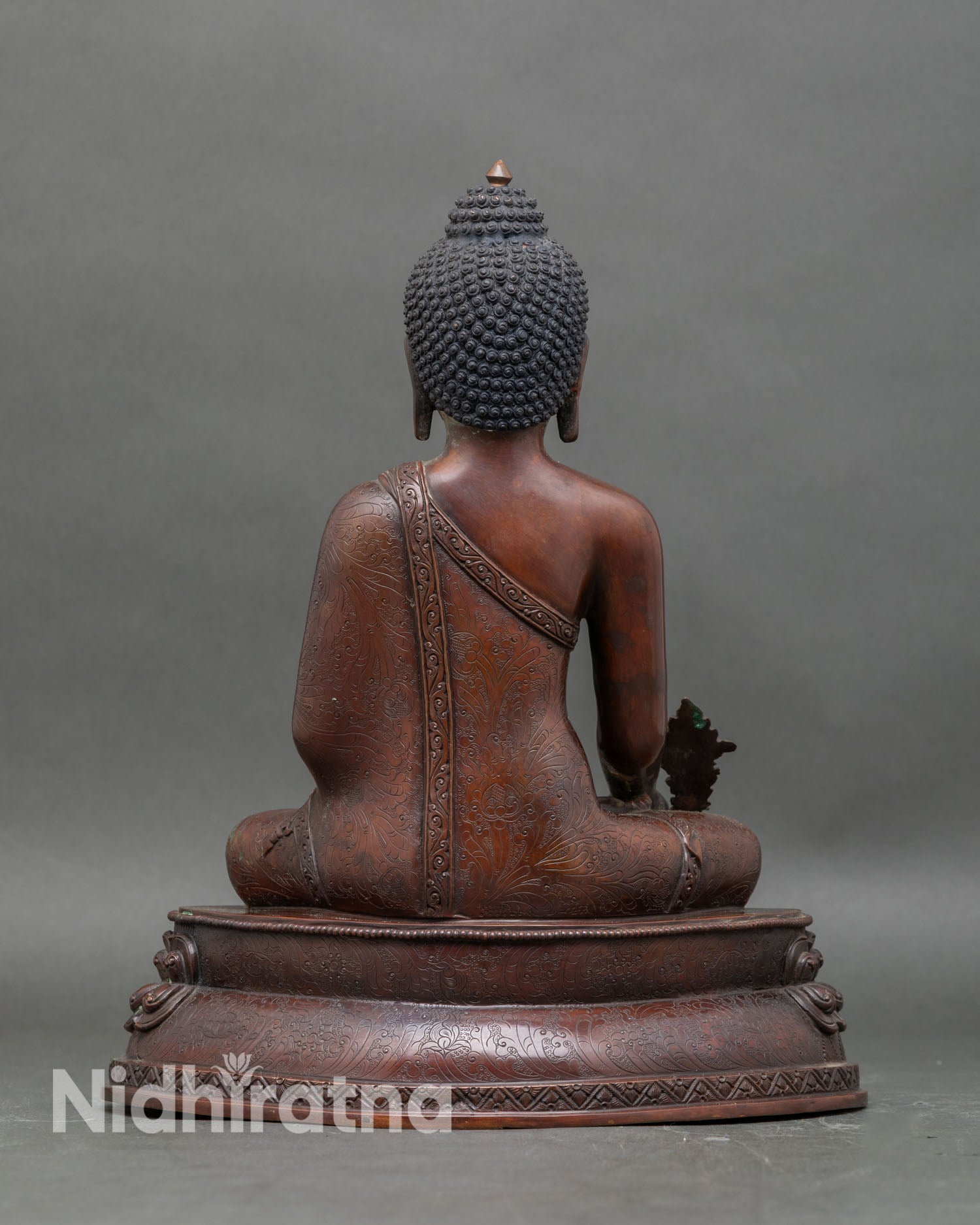 Back view Medicine Buddha seated on lotus pedestal for meditation and spiritual décor