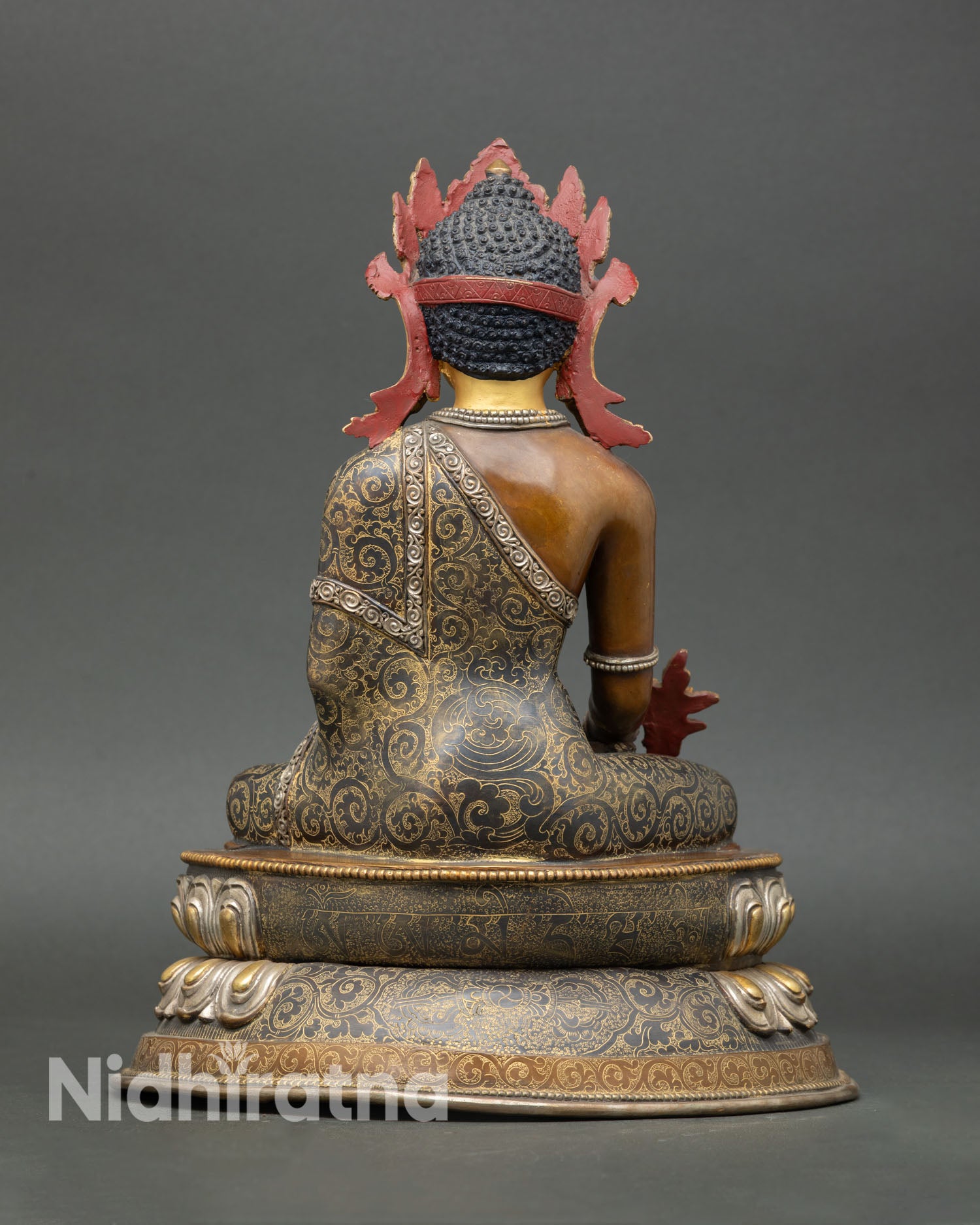 Back view of Medicine Buddha statue Nepal artisan sculpture oxidized copper body ornate lotus base sacred altar decor