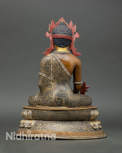 Back view of Medicine Buddha statue Nepal artisan sculpture oxidized copper body ornate lotus base sacred altar decor