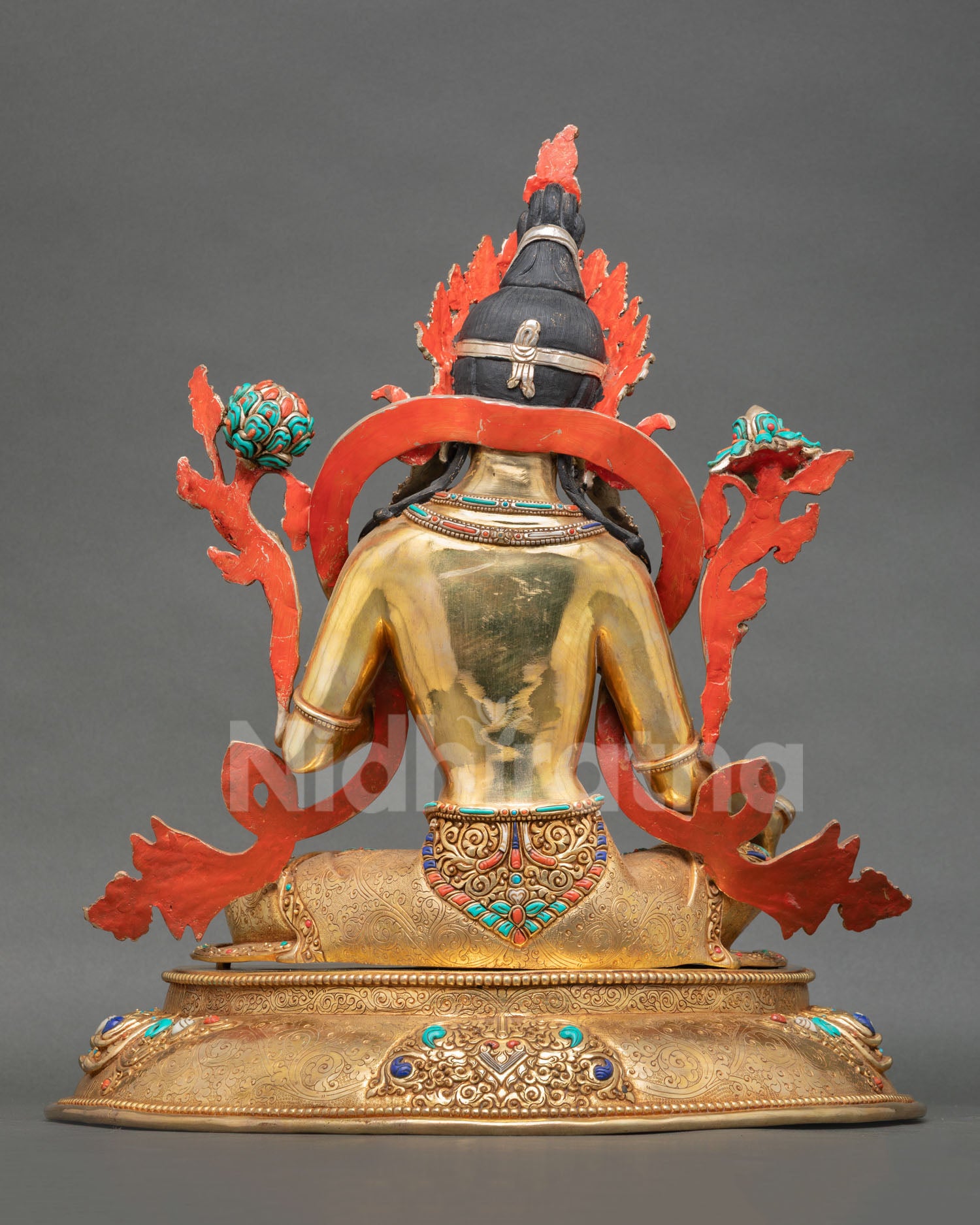 Back view of  Nepalese Green Tara sculpture with engraved metalwork lotus motifs and traditional artisan craftsmanship