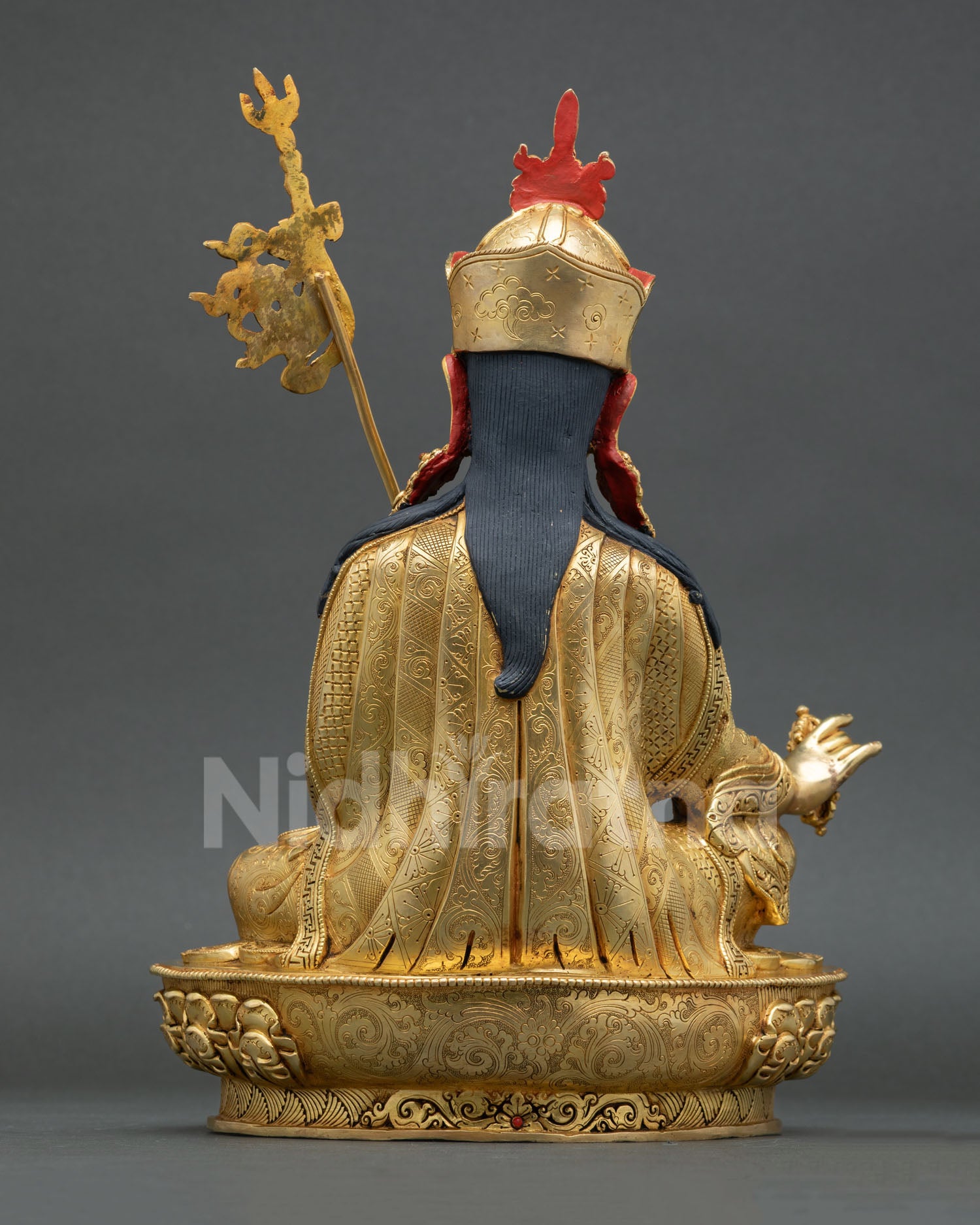 Back view of Nepalese Guru Rinpoche sculpture with detailed metalwork Vajrayana iconography and spiritual altar design