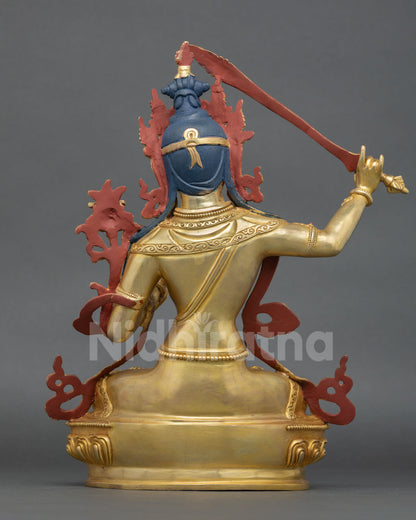 Back view of Nepalese Manjushri sculpture with engraved metalwork Prajnaparamita symbolism and traditional lost wax casting detail