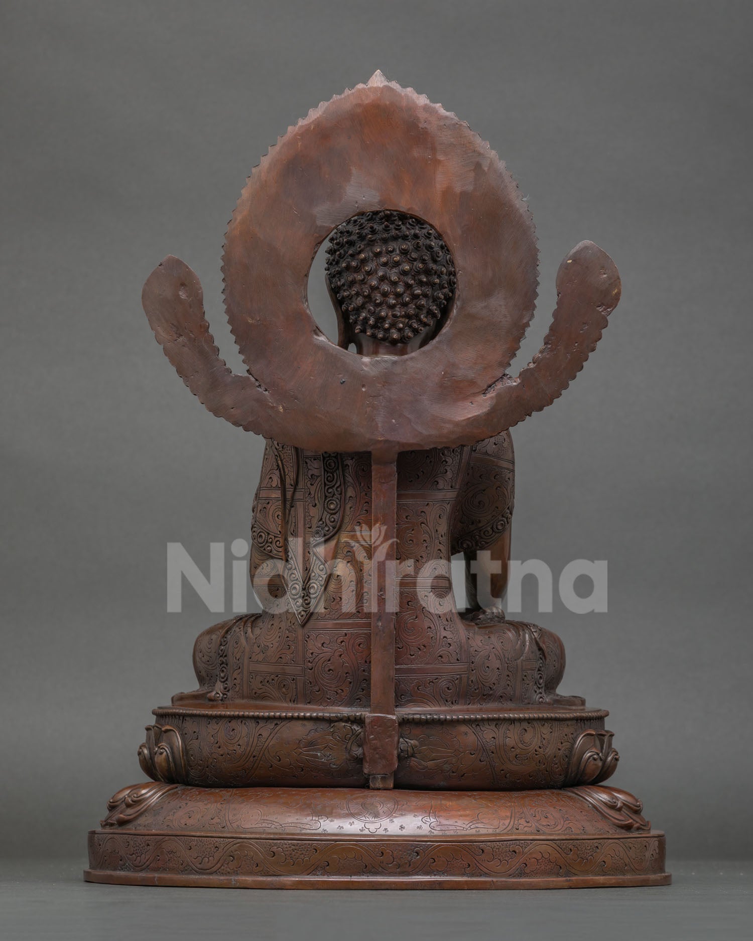 Back view of Nepalese Mitrugpa Buddha statue with decorative halo craftsmanship