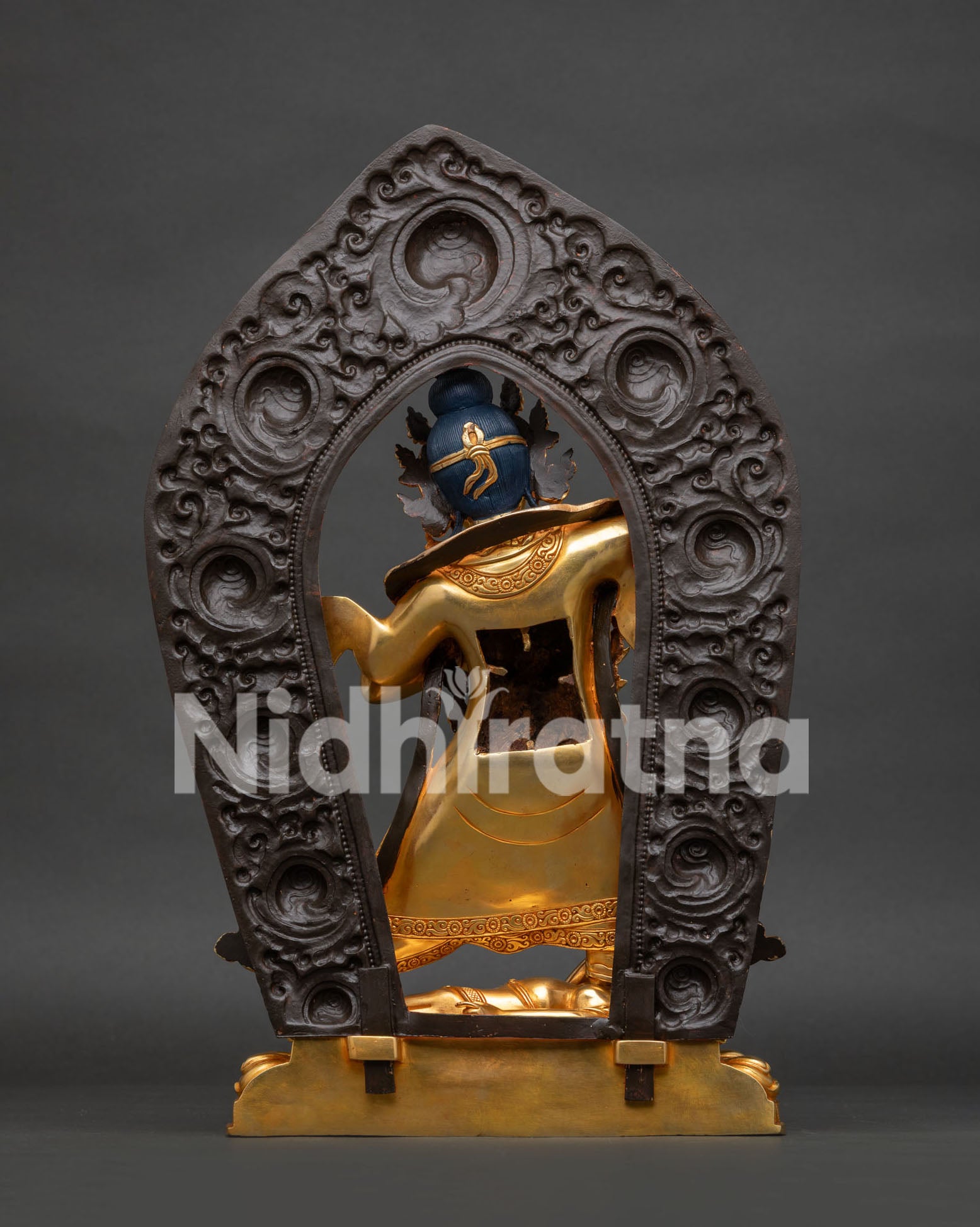 Back view of Achi Chokyi Drolma Statue, showing the aureole's finely carved reverse