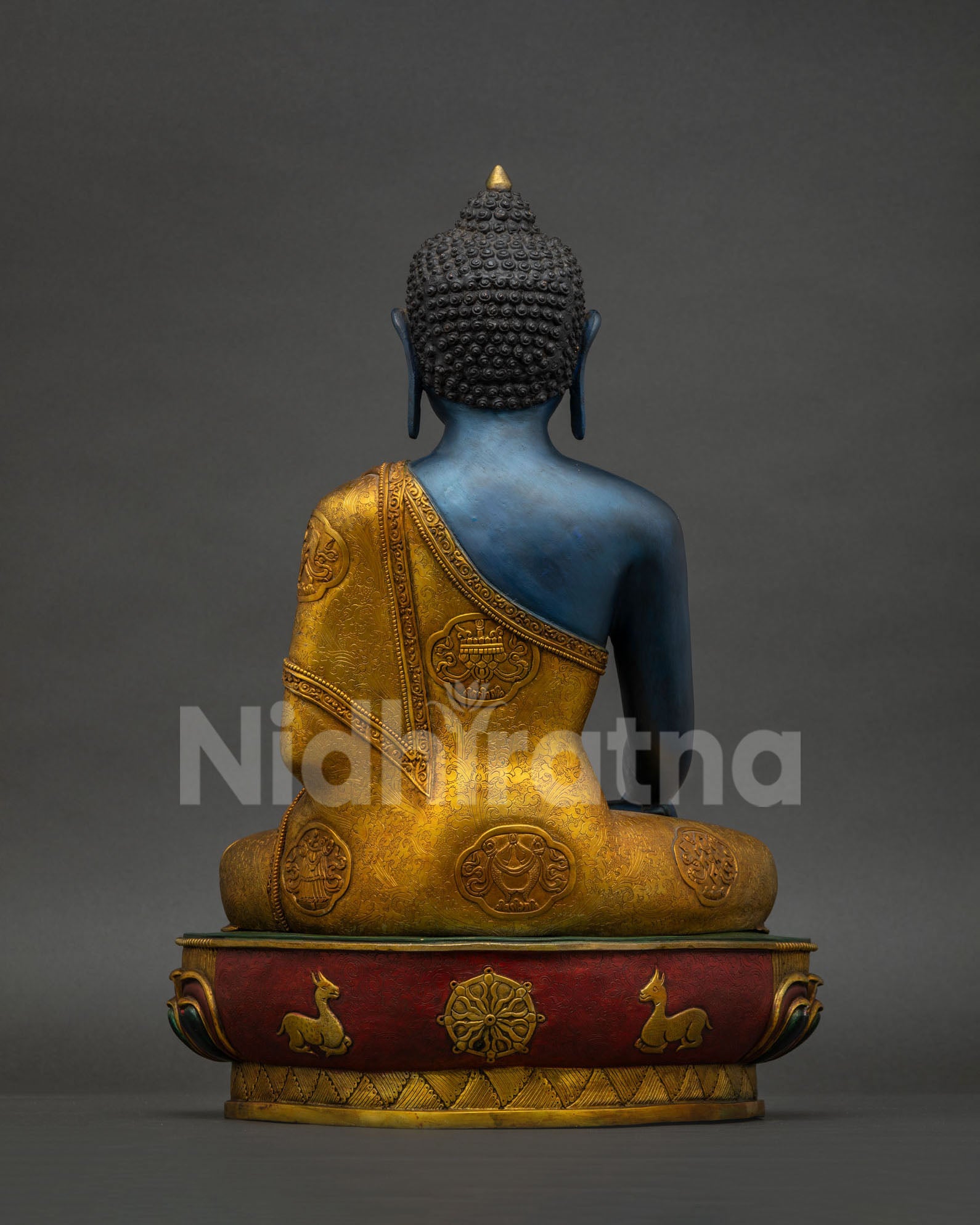 Back view of Akshobhya Buddha statue showing gold gilded robe with Ashtamangala symbols
