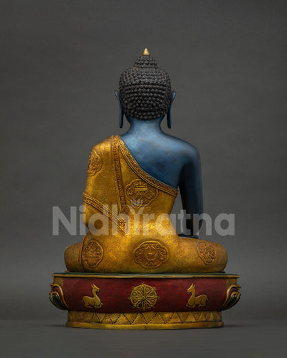 Back view of Akshobhya Buddha statue showing gold gilded robe with Ashtamangala symbols