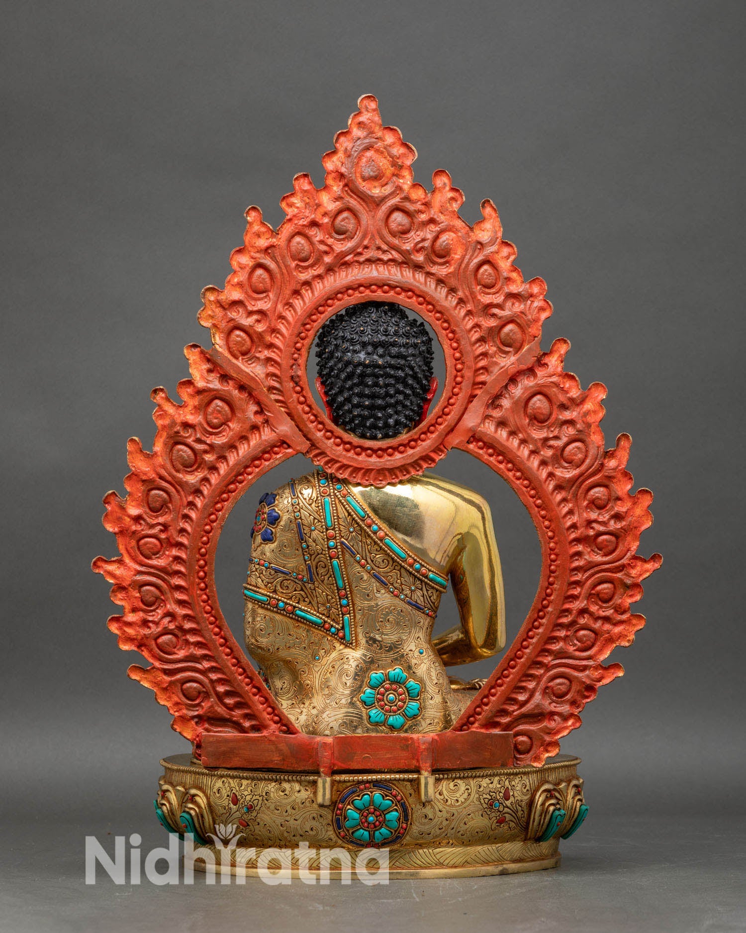 Back view of Amitabha Buddha statue with elaborate halo and ornate lotus pedestal