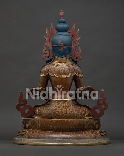 back view of amitayus statue displaying handcrafted repoussé and chased metalwork