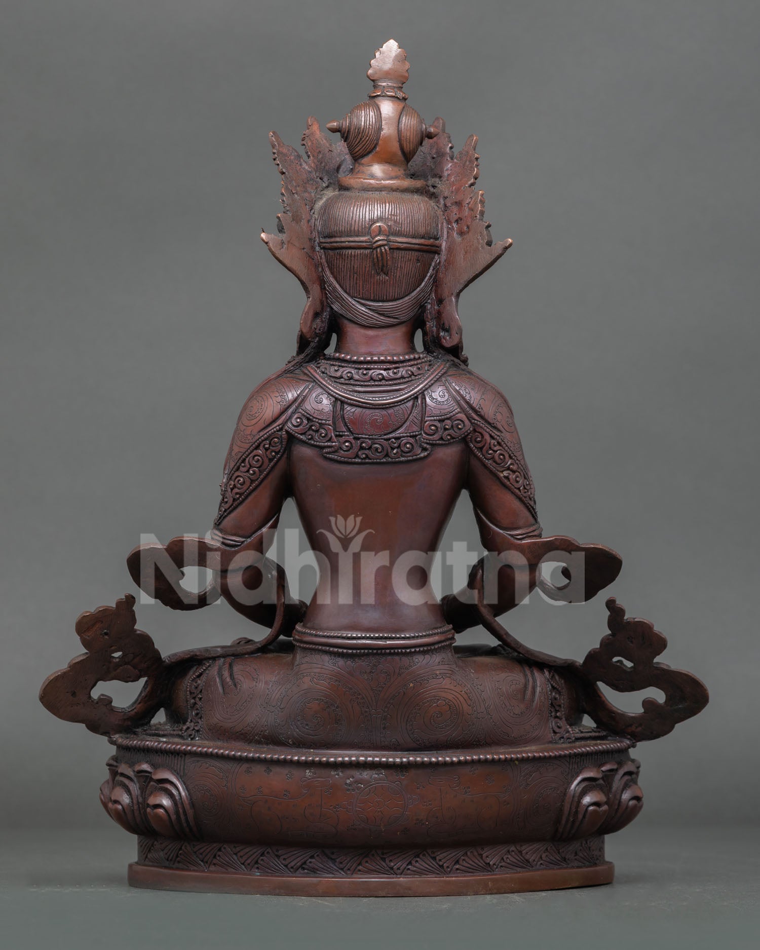 Back view of Amitayus statue showing detailed copper workmanship and aged patina finish