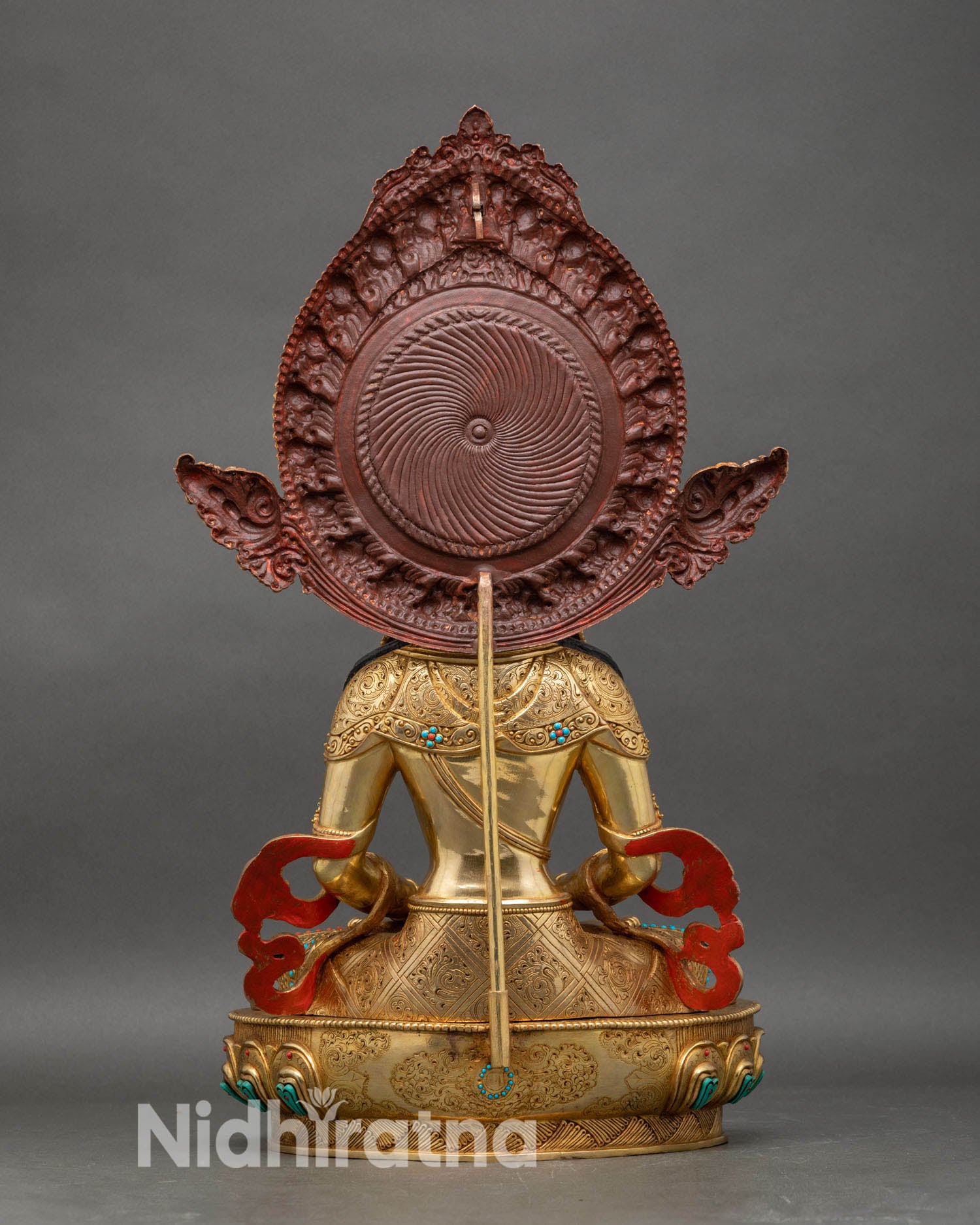 Back view of Amitayus statue showing detailed robe carvings and sacred halo design