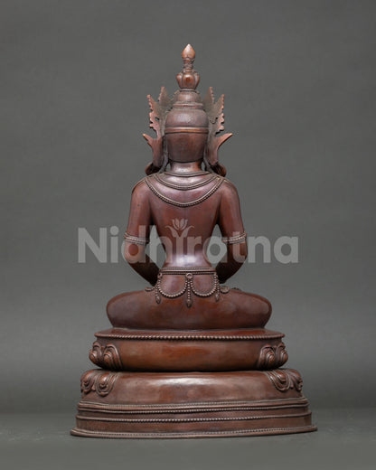 Back view of Amitayus statue showing detailed robes, lotus base, and oxidized copper finish