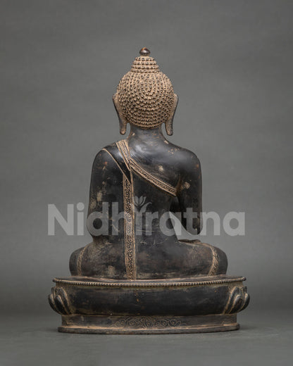 Back view of Amoghasiddhi Buddha statue showing detailed robe, lotus pedestal and copper finish