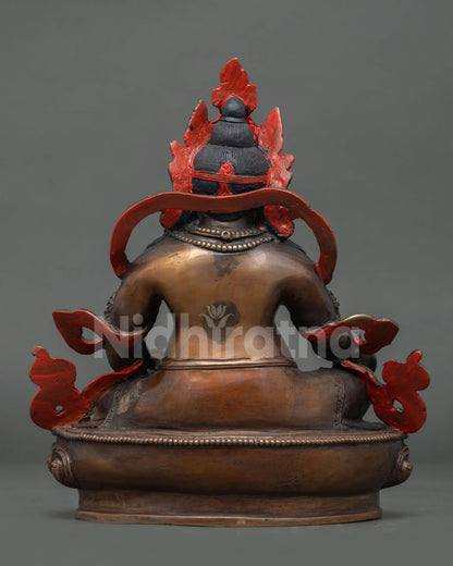 Back view of an oxidized copper Dzambhala statue handcrafted by skilled Newari artisans of Nepal.