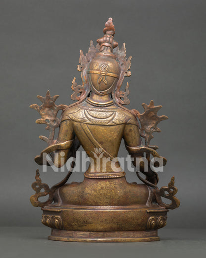 Back view of antique White Tara statue with detailed robes and lotus throne craftsmanship