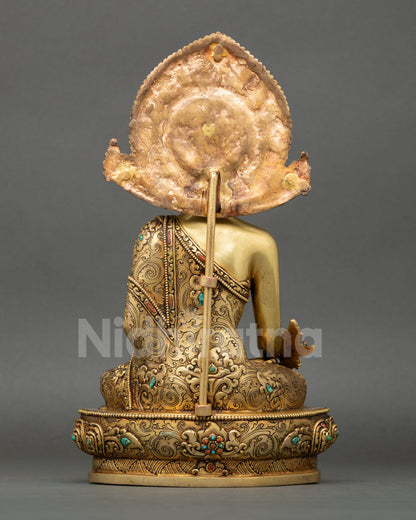 back view of bhaisajyaguru statue showing engraved robes and lotus throne