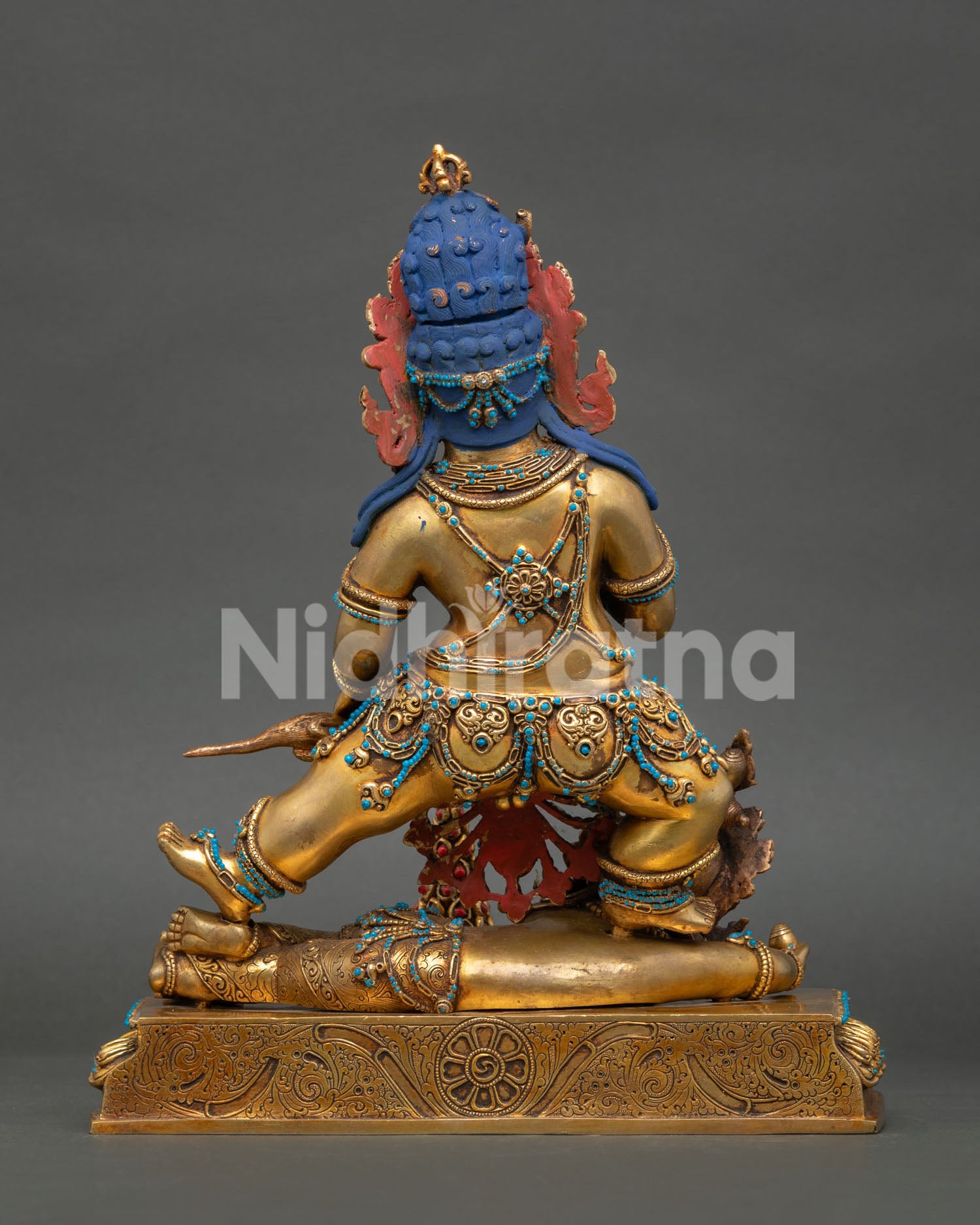 Back view of Black Dzambhala Statue showing antique copper finish and artisan workmanship