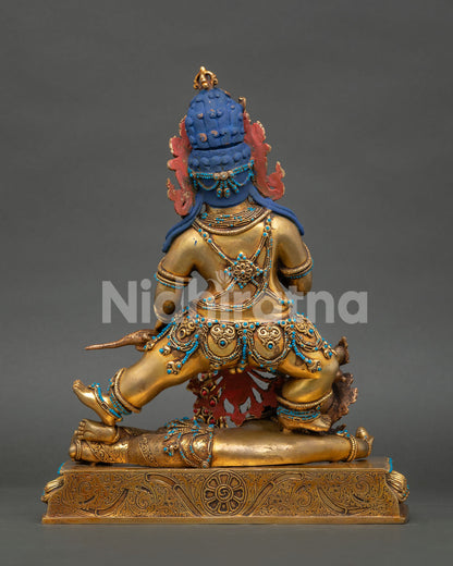 Back view of Black Dzambhala Statue showing antique copper finish and artisan workmanship