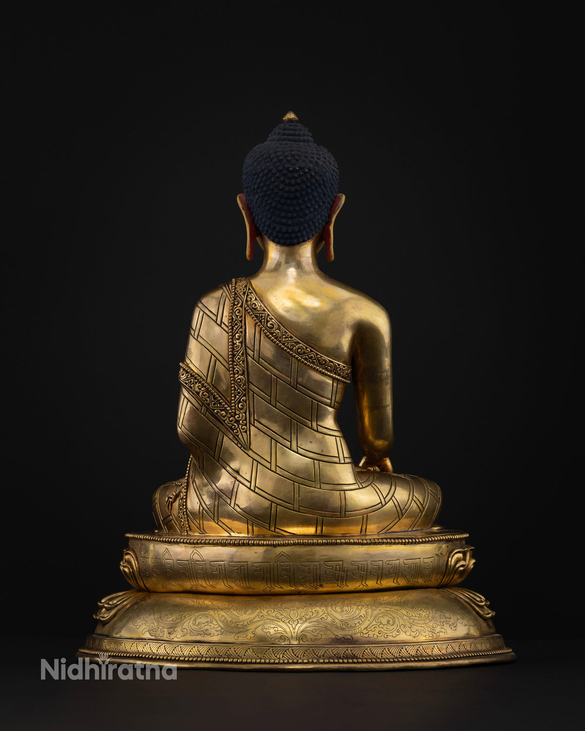 Back view of Buddha Shakyamuni statue highlighting intricate robe carvings, gold-gilded copper, and traditional Newari craftsmanship