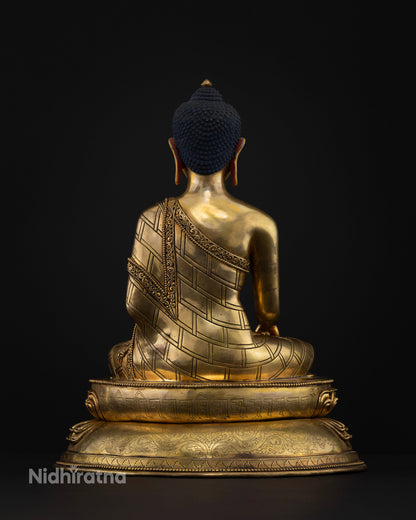 Back view of Buddha Shakyamuni statue highlighting intricate robe carvings, gold-gilded copper, and traditional Newari craftsmanship