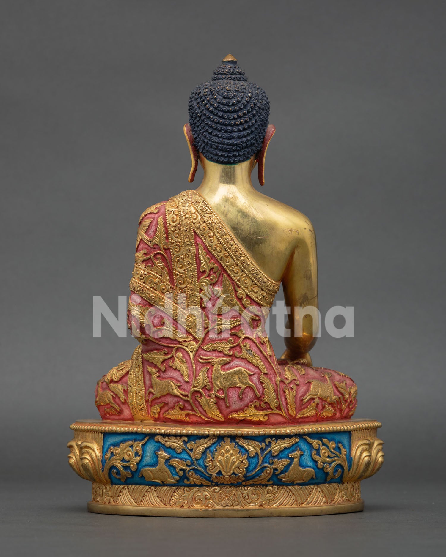 Back view of Buddha Shakyamuni Statue, showing lotus pedestal engraved with sacred deer pairs and Cintamani Jewel design
