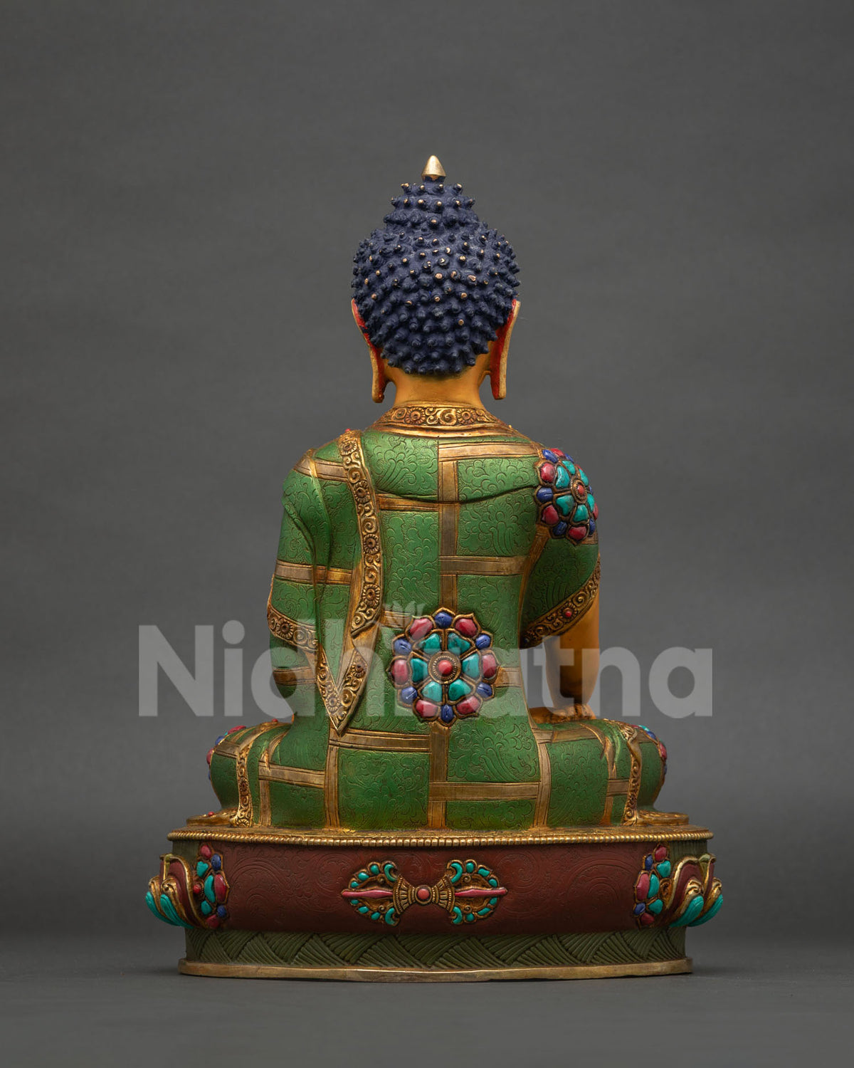 Back view of Buddha statue showing gold fire-gilded crown and robe detail